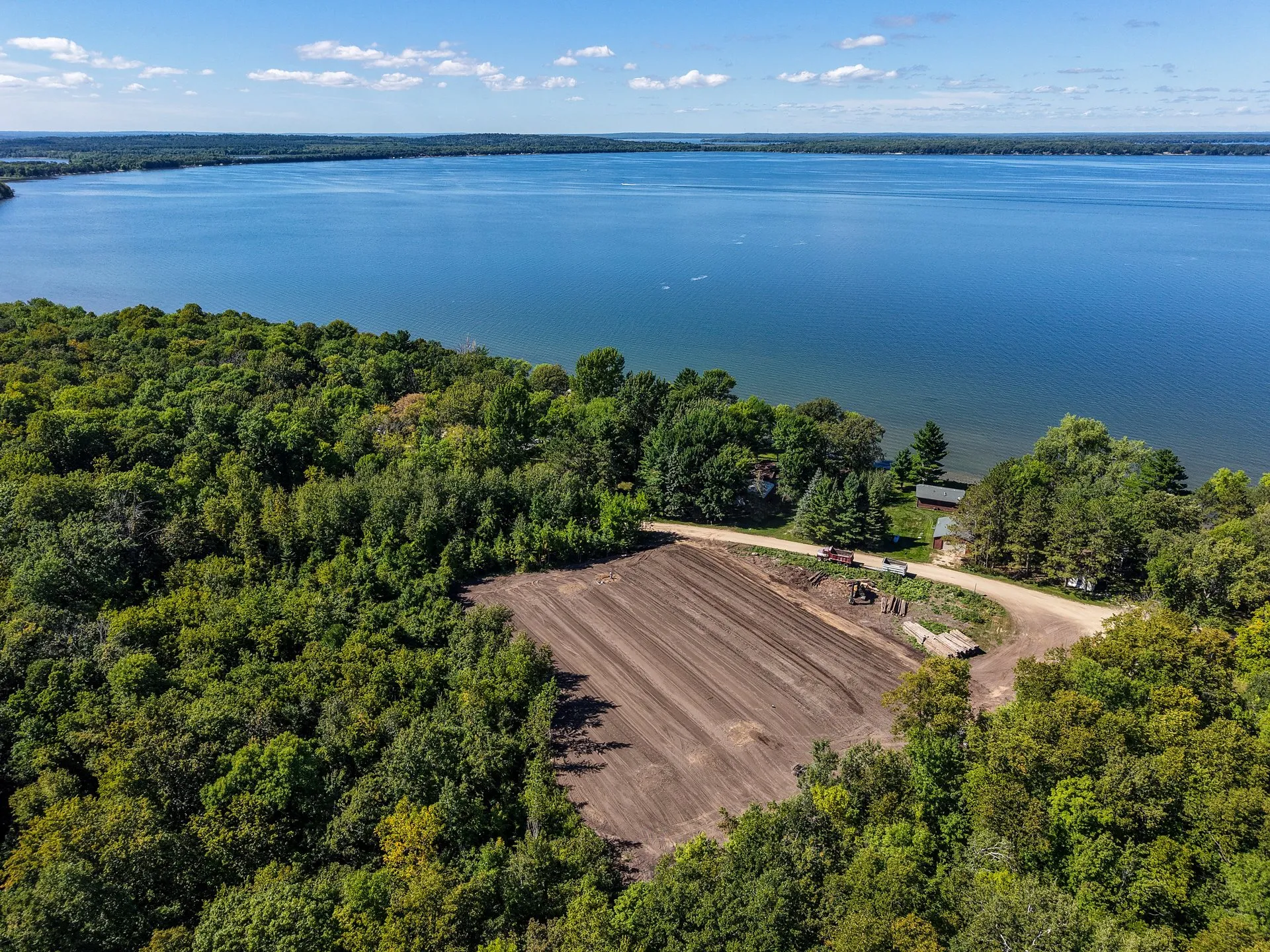 Aerial view of the Leech Lake shoreline near Walker, Minnesota, with a lakefront lot being graded among the trees.